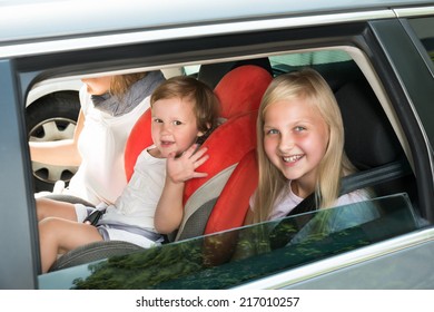 Happy Kids Traveling By Car. Outdoors Shot