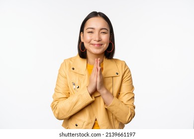 Happy Korean Woman, Looking Hopeful, Asking For Help Favour, Begging, Standing With Namaste Gesture And Smiling, Standing Over White Background