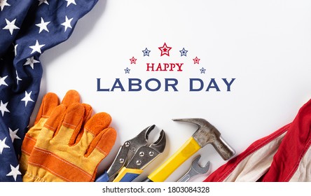 Happy Labor day concept. American flag with different construction tools on white background, with copy space for text. - Shutterstock ID 1803084328
