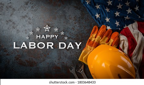 Happy Labor day concept. American flag with different construction tools on dark stone background, with copy space for text. - Shutterstock ID 1803648433