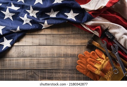 Happy Labor day concept. American flag with different construction tools on dark wooden background. - Shutterstock ID 2180342877