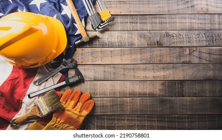 Happy Labor day concept. American flag with different construction tools on dark wooden background. - Shutterstock ID 2190758801