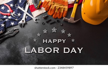 Happy Labor day concept. American flag with different construction tools and the text on dark background. - Shutterstock ID 2348459897