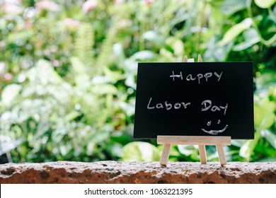 Happy Labor Day Greeting Card Concept, Chalk Board With Text HAPPY LABOR DAY With Green Fresh Garden Background