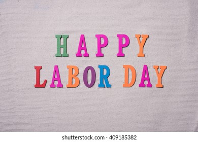 Happy Labor Day On The Sandy Beach Background. Happy Labor Day Word In Colorful Stones