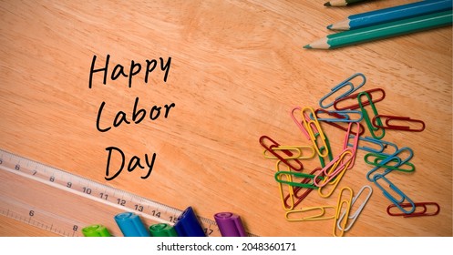 Happy Labor Day Text Over Multiple School Equipment On Wooden Table. Labor Day Celebration Concept