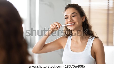 Happy Lady Brushing Teeth With Toothbrush Standing In Bathroom Indoor Foto stock © 