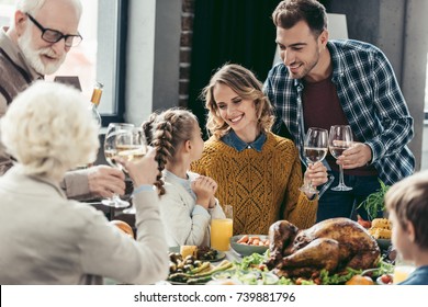 happy large family having holiday dinner on thanksgiving day