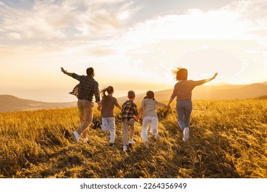 Happy large family: mother, father, children son and  daughters running on nature  on sunset - Powered by Shutterstock