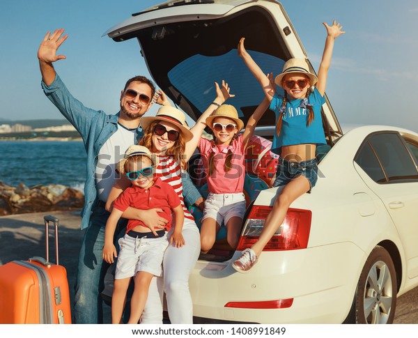 happy large family mother father\
and children in summer auto journey travel by car on\
beach