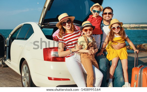 happy large family mother father\
and children in summer auto journey travel by car on\
beach