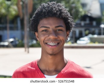 Happy Latin American Guy With Dental Braces Outdoor In The City In The Summer