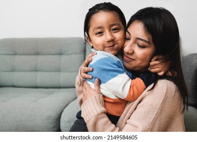 Happy Latin American Mother And Son Hugging Each Other At Home - Family Love Concept - Focus On Child Face