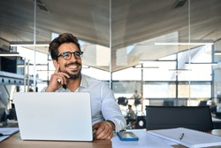 Happy Latin Business Man Working At Laptop In Office Looking Away. Happy Young Businessman Professional Using Computer Sitting At Desk Thinking Of Corporate Technology Ai Solutions. Copy Space