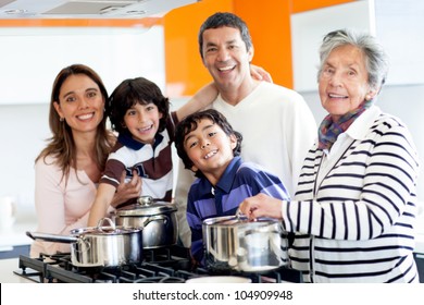 Happy Latin Family Cooking Together At Home