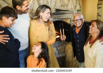 Happy Latin Family Cooking Together At Home Using Barbecue - Focus On Grandfather Face