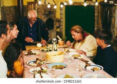 Happy Latin Family Cooking Together During Dinner Time At Home - Soft Focus On Boy Head