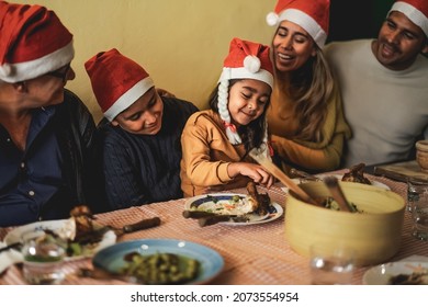 Happy Latin Family Dining Together While Celebrating Christmas Holidays At Home