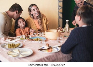 Happy Latin Family Eating Together At Home On Patio