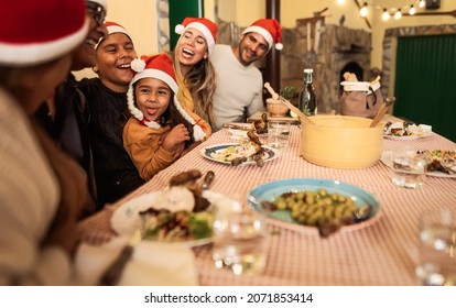 Happy Latin Family Having Fun Celebrating Christmas Holidays While Dining Together At Home