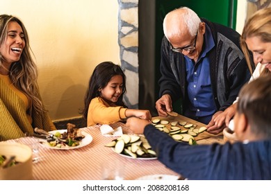 Happy Latin Family Having Fun While Preparing Dinner Together At Home - Children Spending Time With Grandparents During Holidays - Hispanic People And Food Lifestyle Concept