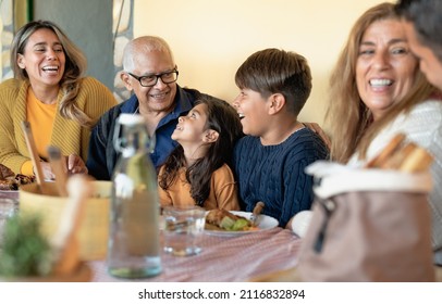 Happy Latin family having fun lunching together at home - Powered by Shutterstock