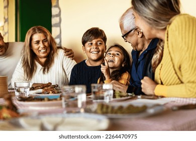 Happy Latin family having fun lunching together at home - Shutterstock ID 2264470975