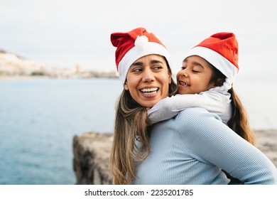 Happy Latin mother enjoying time with her child during Christmas holidays - Family and holidays concept - Powered by Shutterstock