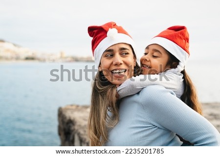 Happy Latin mother enjoying time with her child during Christmas holidays - Family and holidays concept