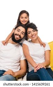 Happy Latin Parents Smiling While Sitting On Sofa Near Daughter Isolated On White