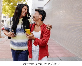 Happy latin transgender woman and her boyfriend walking and using a smartphone - Powered by Shutterstock