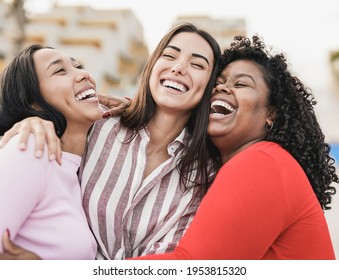 Happy latin women laughing and hugging each other outdoor in the city - Millennial girls and friendship concept - Shutterstock ID 1953815320