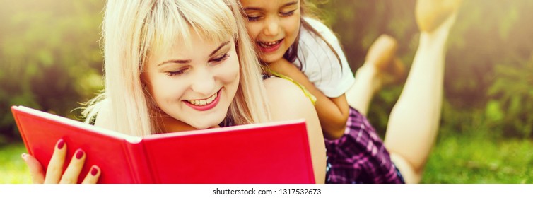 Happy Latino Family Reading Book At Park