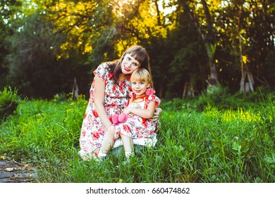 Happy Latino Family Reading Book At Park