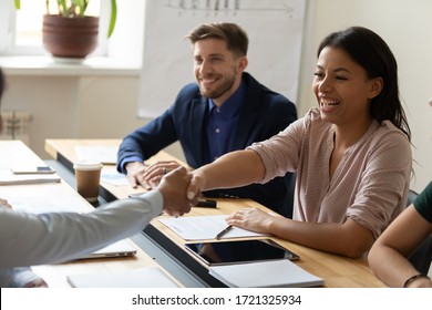 Happy Laugh Hr African American Businesswoman Shaking Hand Of Applicant At Interview. Diverse Female Manager Making Good First Impression. Employer Congratulates Candidate Getting Hired.