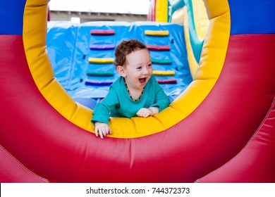 Happy laughing adorable toddler peeking out on trampoline - Powered by Shutterstock