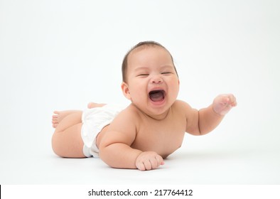 Happy Laughing Child Lies On Stomach, 5 Months Old Asian Baby Boy