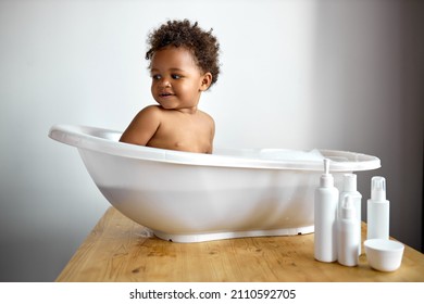Happy Laughing Infant Black Baby Toddler Taking Bath With Foam Bubbles. Bathing And Washing Of Little Kid With Dark Skin. Children Care And Hygiene Concept. Human Emotions, Childhood