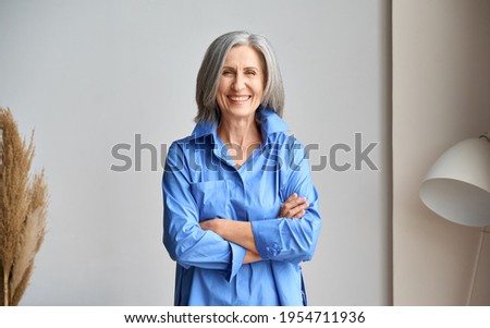 Similar – Foto Bild Frau mit blauer Jacke und langen brünetten Haaren hält den Kopf in den Nacken und tropft mit einer Pipette eine Flüssigkeit in den weit geöffneten Mund