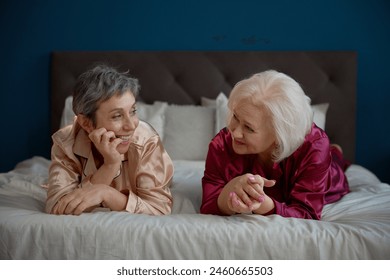 Happy laughing two elderly women enjoying time together during pajama party - Powered by Shutterstock