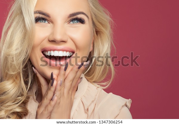 Happy laughing woman, young\
face closeup. Excited girl on colorful background with copy\
space