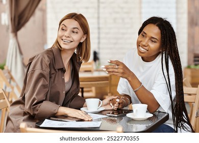 A happy lesbian couple chats and laughs while sharing coffee in a lively cafe setting. - Powered by Shutterstock