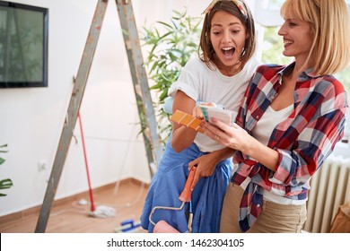 Happy Lesbian Couple Choosing A Color For The New House