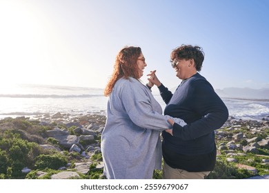 Happy lesbian couple dancing on landscape on sunny day - Powered by Shutterstock