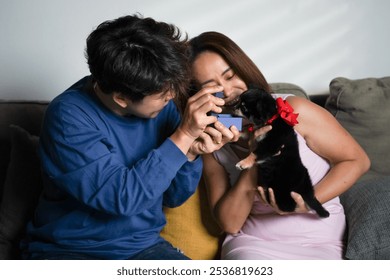 Happy lesbian couple enjoy their just married celebration with chihuahua puppy dog at home. Cheerful Asian LGBTQ gay couple celebrate newlywed in living room. Romantic homosexual people, portrait. - Powered by Shutterstock