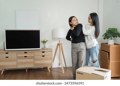 Happy Lesbian Couple Moving into New Home - LGBT loving and New Beginnings - Unpacking Boxes, Decorating, and Creating a Cozy Space Together - Powered by Shutterstock