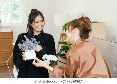 Happy Lesbian Couple Moving into New Home, Unpacking and Decorating Together, Embracing New Beginnings and Love - Powered by Shutterstock