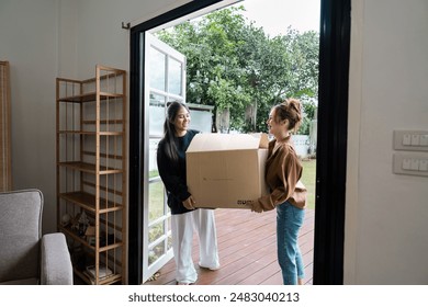 Happy Lesbian Couple Moving into New Home Together, Carrying Boxes and Smiling, Embracing New Beginnings and Fresh Start - Powered by Shutterstock