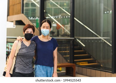 Happy Lesbian Couple In Protective Mask Embracing Each Other. Outdoor