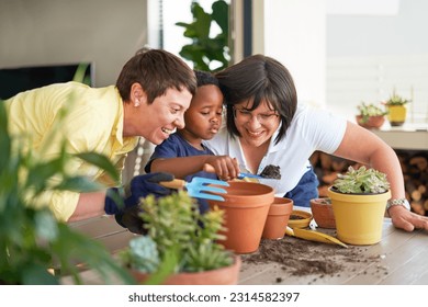 Happy lesbian couple watching son with dirt planting plants in flowerpots on patio - Powered by Shutterstock